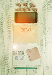 Handwriting text writing Dear Future I Am Ready. Conceptual photo Confident to move ahead or to face the future Envelop smartphone notepad note clip marker paper balls wooden background