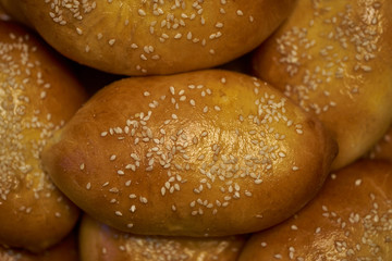 large patties sprinkled with sesame seeds