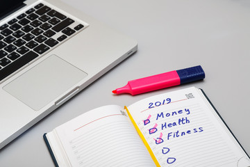 Opened daily organizer with with complete task on the grey background