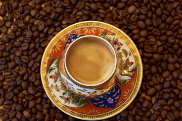 cup of coffee on coffee beans