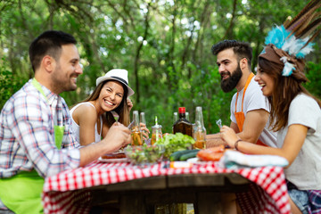 Small group of friends having fun at barbecue party