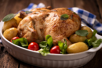 Roasted turkey garnished with potato and veg. Thanksgiving Christmas dinner. Chicken, roasted