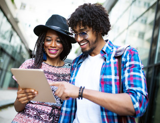 Happy young couple have fun in the city summertime outdoor smiling lifestyle