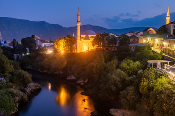 Fototapeta na wymiar Mostar, Old bridge and old town in the evening