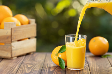 orange juice pouring in glass
