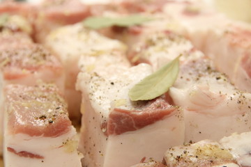 Lard prepared for salting with pepper, bay leaf and salt