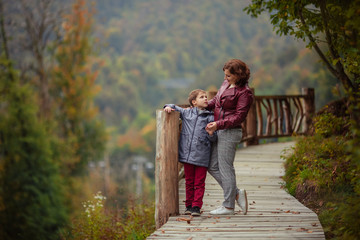 Travelers mother son in the autumn mountains for a walk.