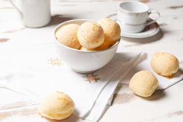 Brazilian snack cheese bread, Homemade cheese buns in arustic style, vintage white wooden background