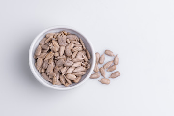 Peeled Sunflower seeds isolated on white background. Soft light, studio shot, copy space.