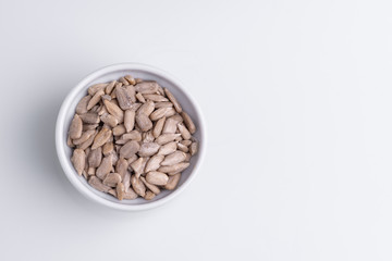 Peeled Sunflower seeds isolated on white background. Soft light, studio shot, copy space.