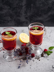 Red tea with raspberries in glass