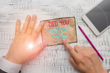Handwriting text writing Did You Workout Today. Conceptual photo asking if made session physical exercise Hand hold note paper near writing equipment and modern smartphone device