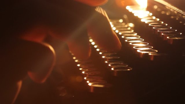 Close up shot of man typing on old vintage retro typewriter; backlit; news, media or communication concept