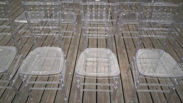 Transparent plastic chairs for wedding guests.