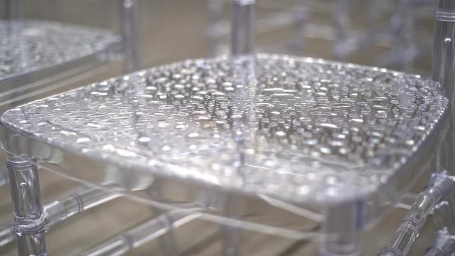 Transparent plastic chairs for wedding guests.