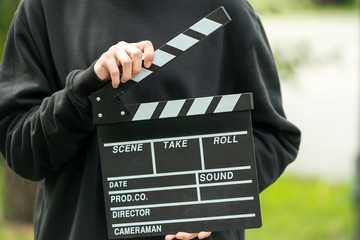 Man with clapperboard outdoor