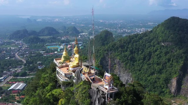 Aerial view Tiger Cave Temple, Buddha on the top Mountain with blue sky of Wat Tham Seua, Krabi,Thailand 