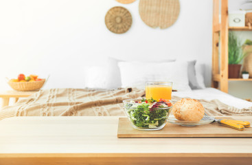 Tasty healthy breakfast on table in bedroom