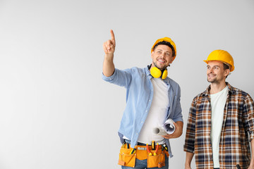 Portrait of architects on light background