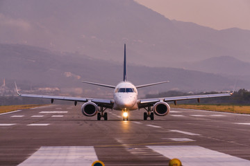 Sunset view of Airport of Tivat, Montenegro, with take-off planes.