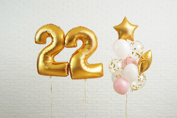 Figure 22 and different balloons on light background - obrazy, fototapety, plakaty
