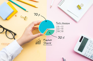 Market share concepts with business person sharing chart diagram on desk table office