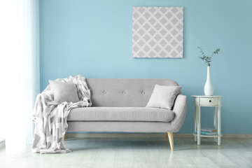 Interior of light modern room with comfortable sofa