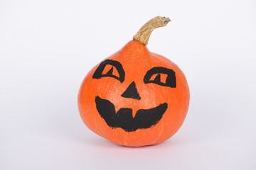 The orange pumpkin painted for Halloween on white background
