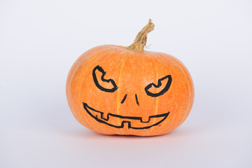 The orange pumpkin painted for Halloween on white background