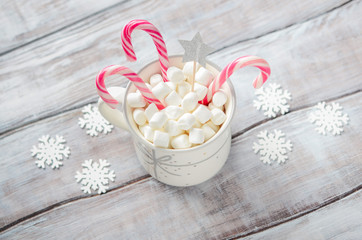 New Year or Christmas concept. Composition with marshmallows and candy canes on a wooden  background. 