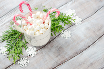 New Year or Christmas concept. Composition with marshmallows and candy canes on a wooden  background. 