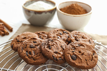Tasty chocolate cookies on cooling rack, closeup