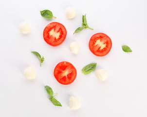 Fresh tomato, basil and mozzarella cheese on white background
