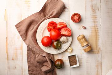 Plate with fresh tomatoes on wooden table