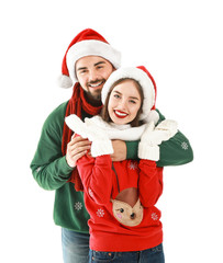 Happy young couple in Christmas clothes on white background