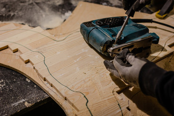 Carpenter working with an electric jigsaw