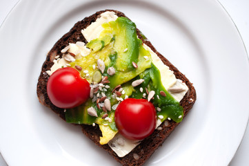 Breakfast rye bread sandwich with mozzarella and avocado