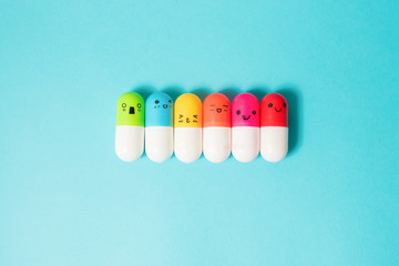 Bright colored pills on blue background