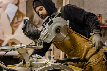 Carpenter using circular saw for wood