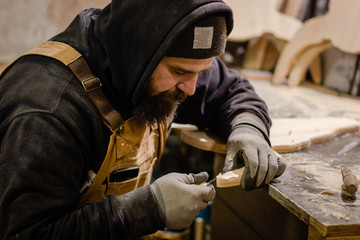 Carpenter using gouge for wood