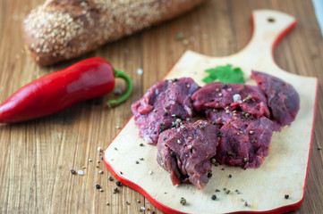 appetizing fresh meat with spices on a cutting Board