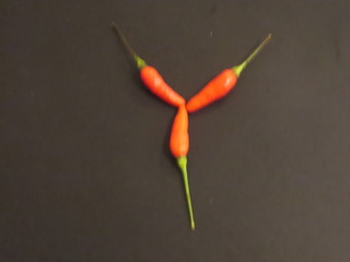 red chili peppers on black background