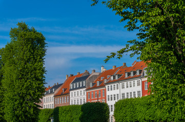 Fototapeta na wymiar Scenic summer view of the ancient classic colorful houses with blue sky. Famous Nyhavn pier with colorful facades of old houses and vintage ships in Copenhagen, capital of Denmark