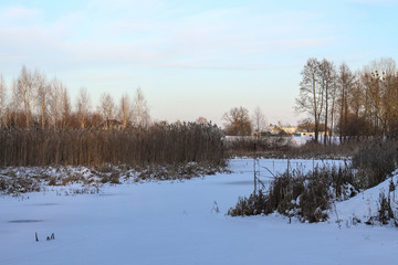 Beautiful winter landscape with a snowy river and lake. Christmas and New Year theme