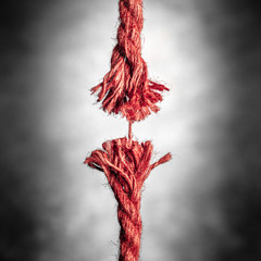 Frayed Red Rope Hanging By Last Thread On Black And White Background