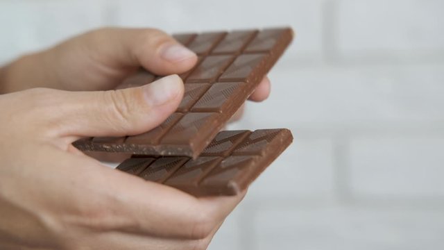 Breaking a bar of chocolate.