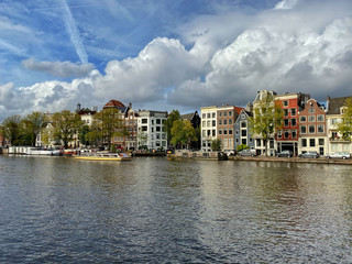 Fototapeta na wymiar Amsterdam canal with typical dutch houses and houseboats, boats etc.