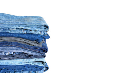 Stack on many colored blue jeans isolated on white background with empty space for text at right side of Photo