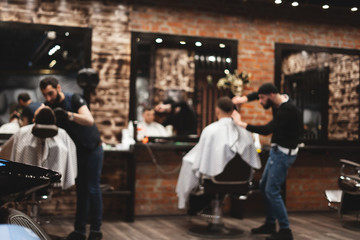 Haircut head in barbershop. Barber cuts the hair on the head of the client. The process of creating hairstyles for men. Barber shop. Selective focus. - obrazy, fototapety, plakaty