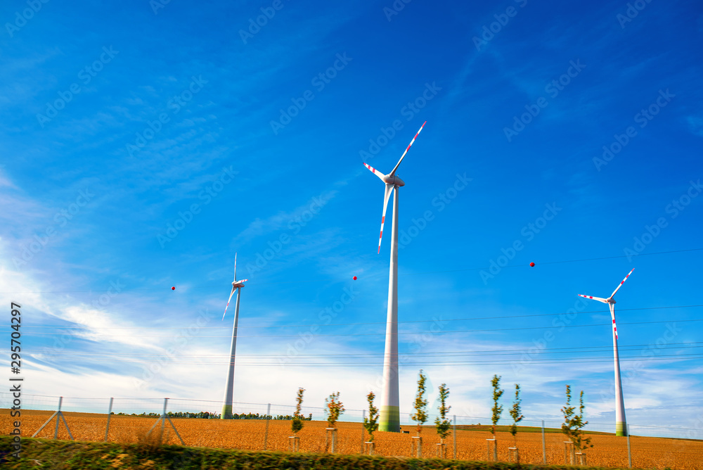 Wall mural green technology concept. wind generators in field